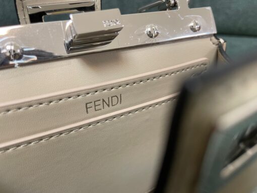 FENDI Peekaboo Cut. Original Quality Bag including gift box, care book, dust bag, authenticity card. Peekaboo Cut bag made of glossy leather. A new evolution of the iconic Peekaboo ISeeU, it has a striking horizontal cut that accentuates its classic features and reveals the metal bar and the iconic twist lock on both sides. It can be carried by hand or on the shoulder thanks to the chain embellished with O’Lock details. | CRIS AND COCO Authentic Quality Luxury Accessories