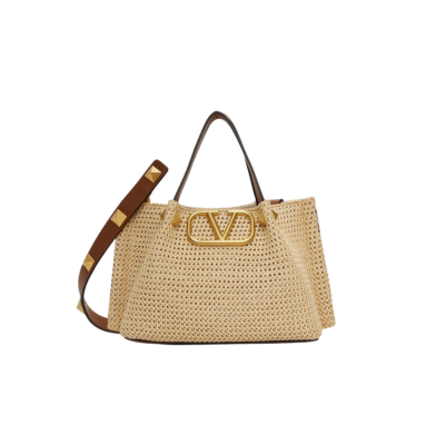 VALENTINO GARAVANI Straw Summer Small Tote.  Original Quality Bag including gift box, literature, dust bag, authenticity card. The Summer tote bag is defined by its woven raffia design and the brass-toned VLogo plaque, the unmistakable symbol of Valentino Garavani. The detachable shoulder strap is adorned with the iconic Roman Studs, another of the brand's signature details. | CRIS AND COCO Authentic Quality Luxury Accessories
