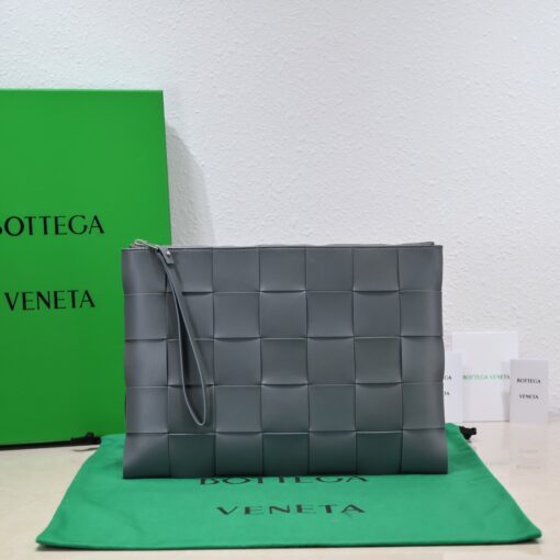 BOTTEGA VENETA Large Intreccio Leather Pouch.  High-End Quality Bag including gift box, care book, dust bag, authenticity card. This stylish zipped pouch from Bottega Veneta is a handy accessory to have. It is expertly crafted from a luxurious leather featuring the signature Intreccio weave. It features a removable wristlet so you can carry it however you desire. It also has a smooth leather interior lining which adds to its fine quality. It closes with a reliable metal zipper that runs across the top. Its multifunctional design makes it an essential addition to any wardrobe. | CRIS AND COCO Authentic Quality Luxury Accessories