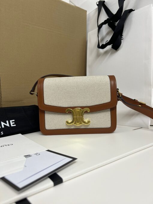 CELINE Teen Triomphe. High-End Quality Bag including gift box, care book, dust bag, authenticity card. In 2018, Hedi Slimane released the original Triomphe to much acclaim. Since then, the stylish purse has been spotted on the arms of celebrities and fashion insiders across the world. With its smooth leather exteriors and minimalistic hardware, the crossbody design reconciles fashion and function, featuring Celine's signature golden Triomphe logo fastener. It has attracted the attention of bag collectors and fashion historians alike for its sophisticated yet simple design. This classic piece has inspired a series of spinoffs, proving its timelessness and forever cementing the Triomphe as a fashion icon. | CRIS AND COCO Authentic Quality Luxury Accessories