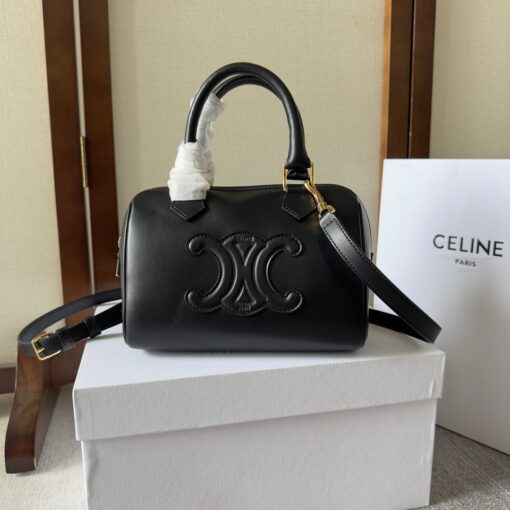 CELINE Small Boston Cuir Triomphe. Style meets sophistication with this timeless Celine Bag. The Celine Small Boston Cuir Triomphe is a classic accessory that is perfect for both day and night. It is made out of smooth calfskin leather with a stitched monogram pattern that creates an elegant, modern look. The bag features a removable and adjustable shoulder strap, a top handle for carrying, and a zipped closure. It also has a main spacious compartment, and one inner flat pocket. It has a small and compact size, perfect for days when you don't want to carry too much. The timeless design will never go out of style, and you'll be sure to feel confident and stylish with this bag on your arm. | CRIS AND COCO Authentic Quality Luxury Accessories