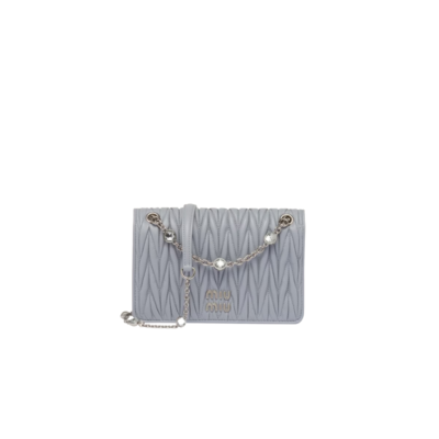 MIU MIU Matelassé Mini Bag: Elevate your style with this sophisticated and three-dimensional leather mini-bag. The exquisite craftsmanship of matelassé gives this nappa leather mini-bag a beautifully intricate and 3D appearance. The lettering logo on the flap perfectly complements the metallic hardware, accentuating the impeccable artisanal workmanship and creating an instantly recognizable symbol. With its elegant and compact silhouette, chain shoulder strap with shoulder pad, and convenient magnet closure, this bag is both practical and visually appealing in every detail. | CRIS&COCO Authentic Quality Designer Bags and Luxury Accessories