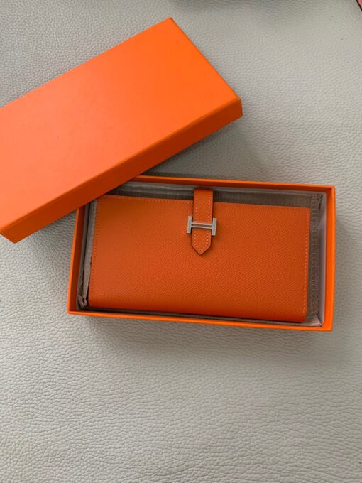 HERMÈS Béarn Wallet: Where Elegance Meets Functionality, Inspired by the Heart of France's South-West. The Béarn pays homage to the enchanting South-West region of France and stands as a distinguished member of a collection that honors various distinctive French regions. This wallet or card holder boasts an elegantly sleek design and is thoughtfully equipped with multiple compartments tailored for organizing credit cards, coins, and bills with ease. Upon closure, a supple leather flap gracefully glides into an iconic "H" shaped clasp, elevating it to a timeless classic. It presents a generous array of leather types and colors, allowing one to harmonize effortlessly with the latest trends in style. | CRIS&COCO Authentic Quality Designer Bags and Luxury Accessories