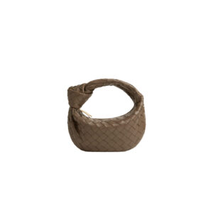 Mini Jodie. Mini Marvel: Elevate Your Essentials. Introducing the BV Mini Jodie by Daniel Lee, a captivating embodiment of the mini bag trend infused with a captivating minimalist essence. True to the distinctive allure of the Jodie collection, this rendition showcases the iconic Intrecciato weave and the signature knot embellishment. Delicately compact, it effortlessly nestles under your arm akin to a charming baguette bag, yet offers ample space for your essentials such as your phone, cards, and keys. Despite its diminutive size, this mini bag radiates a vibrant aura through an array of lively hues, ensuring it leaves a memorable impression. | CRIS&COCO Authentic Quality Designer Bags and Luxury Accessories