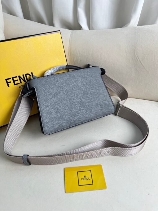 FENDI Peekaboo ISeeU XCross: Unlock True Luxury. Presenting the Iconic Peekaboo ISeeU XCross bag, meticulously crafted from exquisite full-grain leather. Its interior boasts two well-organized compartments separated by a sturdy partition. The front showcases an iconic twist lock, while the back features a secure zip fastening. The bag's interior is lined with matching leather and includes a contrasting cardholder slot, all complemented by palladium-finish metalware. Carry it with grace either by hand using the sturdy handle or effortlessly on your shoulder with the adjustable, detachable shoulder strap in webbing adorned with Fendi lettering. This bag seamlessly combines style and functionality, making it an essential luxury accessory.