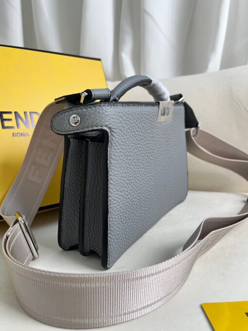 FENDI Peekaboo ISeeU XCross: Unlock True Luxury. Presenting the Iconic Peekaboo ISeeU XCross bag, meticulously crafted from exquisite full-grain leather. Its interior boasts two well-organized compartments separated by a sturdy partition. The front showcases an iconic twist lock, while the back features a secure zip fastening. The bag's interior is lined with matching leather and includes a contrasting cardholder slot, all complemented by palladium-finish metalware. Carry it with grace either by hand using the sturdy handle or effortlessly on your shoulder with the adjustable, detachable shoulder strap in webbing adorned with Fendi lettering. This bag seamlessly combines style and functionality, making it an essential luxury accessory.