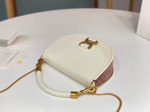 CHLOÉ Marcie Chain Flap Bag. Elevating Iconic Elegance: Marcie Line Redefined. Experience a fresh take on Chloé's iconic Marcie line with this exquisite chain flap bag, meticulously crafted from a captivating blend of nappa lambskin, grained calfskin, and sumptuous suede. The line's signature hardware undergoes a graceful transformation, now adorned with Chloé's engraved jewelry hallmark, adorning the flap with sophistication. An intricately hand-braided top handle pays homage to another hallmark Marcie feature, while a gracefully extended chain strap adds a refined touch. Whether you choose to drape it over your shoulder or wear it cross-body during the day, or opt to detach the strap and carry it by hand for a sophisticated evening ensemble, this flap bag is a versatile masterpiece. Chloé's Marcie bag line effortlessly melds a feminine aesthetic with the free-spirited vibe of the '70s. An equestrian-inspired allure takes center stage, elevated by the allure of gleaming gold-toned hardware, resulting in a distinctly feminine yet timelessly chic look.