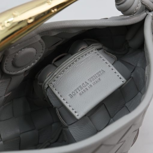 BOTTEGA VENETA Mini Sardine. Crafted to Perfection, Inspired by Nature: Your Timeless Companion for All Occasions. Bottega Veneta's masterful intrecciato weaving technique was originally crafted to ensure the enduring quality of leather goods. The Sardine Mini leather shoulder bag, meticulously fashioned from supple lamb leather, showcases a distinctive top handle reminiscent of a graceful fish. This versatile piece seamlessly transitions from day to night, making it the perfect, reliable companion to elegantly accommodate all your essentials.