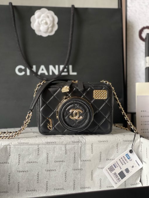 CHANEL Camera Bag. A pinnacle of timeless elegance and contemporary sophistication. This iconic piece showcases exquisite craftsmanship and meticulous attention to detail. The camera bag design exudes versatility and style, offering a modern reinterpretation of a classic silhouette. Made from premium materials, it boasts buttery-soft lambskin leather, adorned with the iconic quilted pattern synonymous with CHANEL's heritage. With its compact yet spacious interior, the Camera Bag effortlessly accommodates all your essentials while maintaining a sleek and streamlined profile. The signature Chanel interlocking CC logo adorns the front, adding a touch of unmistakable luxury to the design.