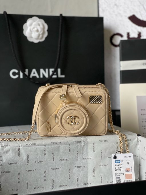 CHANEL Camera Bag. A pinnacle of timeless elegance and contemporary sophistication. This iconic piece showcases exquisite craftsmanship and meticulous attention to detail. The camera bag design exudes versatility and style, offering a modern reinterpretation of a classic silhouette. Made from premium materials, it boasts buttery-soft lambskin leather, adorned with the iconic quilted pattern synonymous with CHANEL's heritage. With its compact yet spacious interior, the Camera Bag effortlessly accommodates all your essentials while maintaining a sleek and streamlined profile. The signature Chanel interlocking CC logo adorns the front, adding a touch of unmistakable luxury to the design.