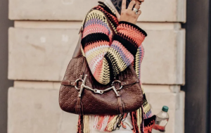 Brown designer handbag with sleek, structured silhouette and elegant detailing