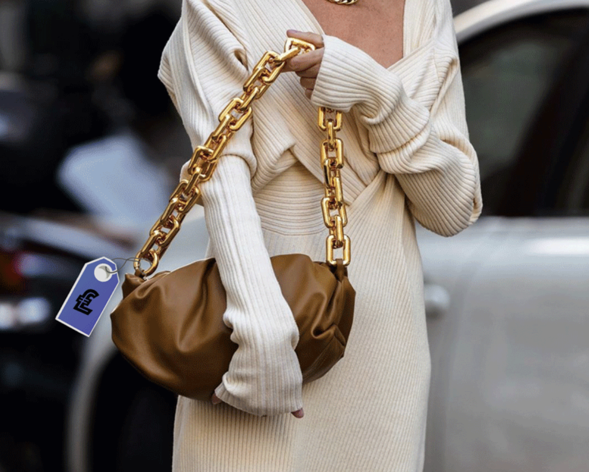 Confident woman carrying a BOTTEGA VENETA bag at a fashion event.