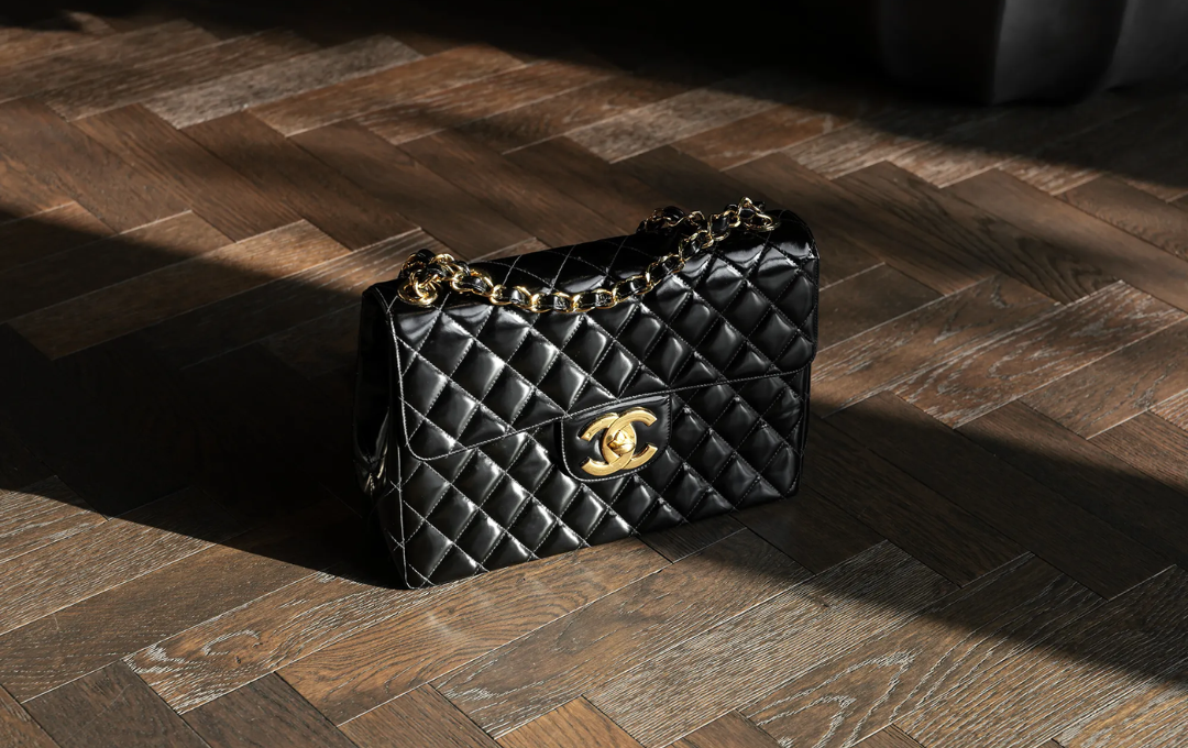 CHANEL Classic Flap Bag in black leather with gold chain details