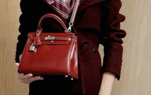 Red Hermès Kelly bag with classic structured silhouette and gold hardware