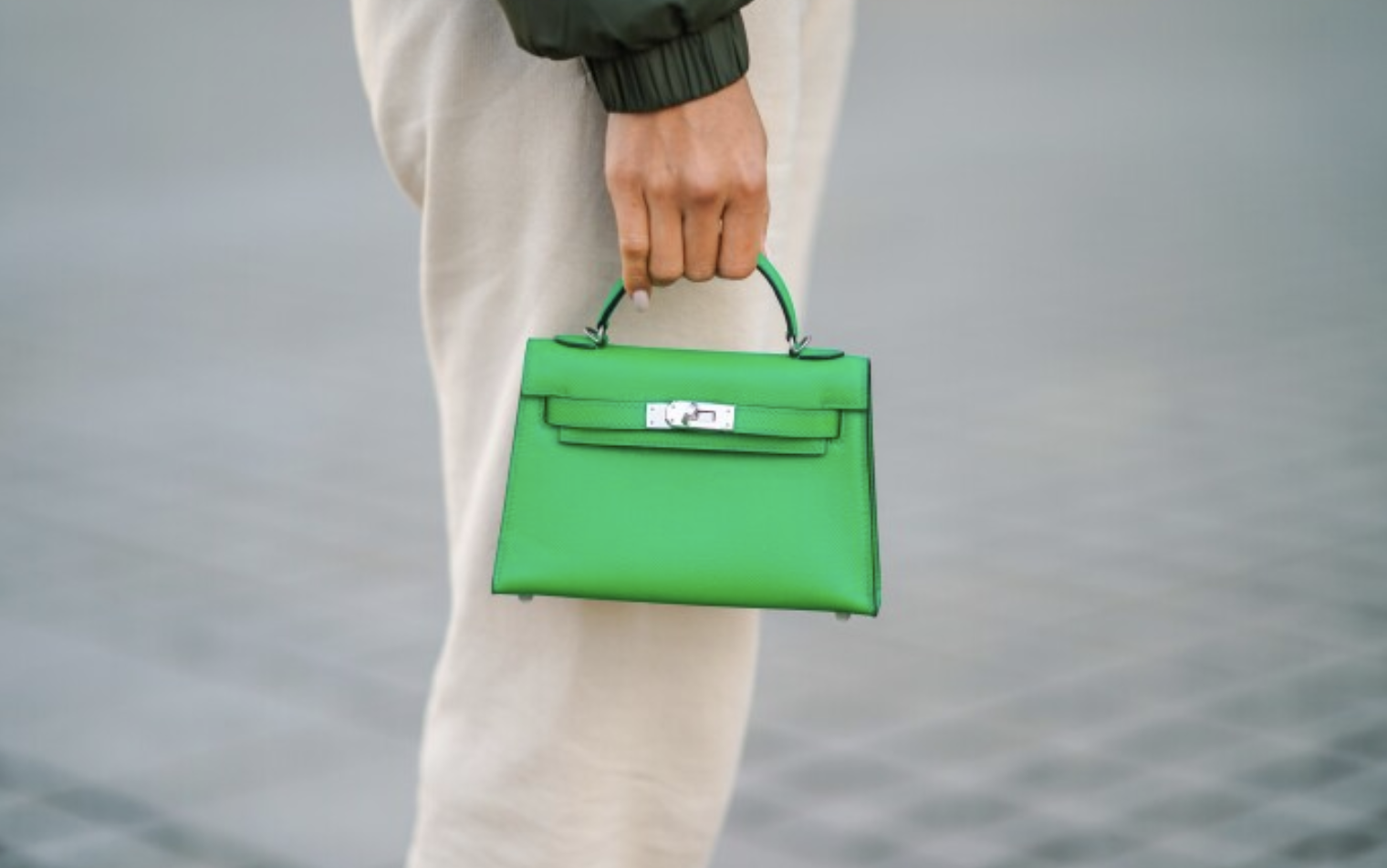 Green Hermès Kelly bag with classic structured shape and silver hardware