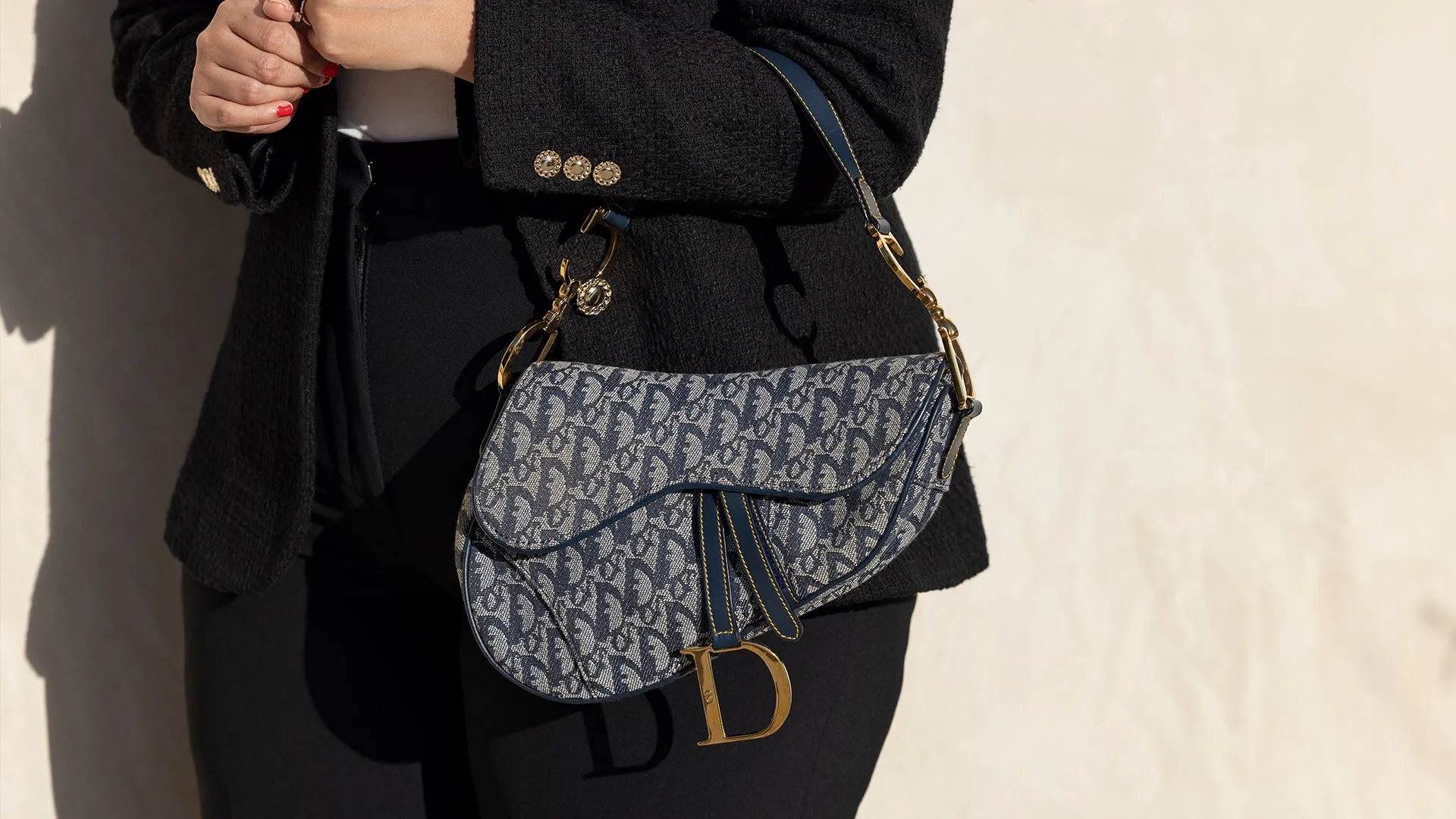 A close-up of a DIOR Saddle Bag with intricate embroidery.