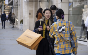 A group of millennials shopping luxury items.