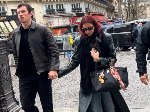 Dua Lipa photographed with her black HERMÈS Birkin bag while out and about, exuding effortless chic.