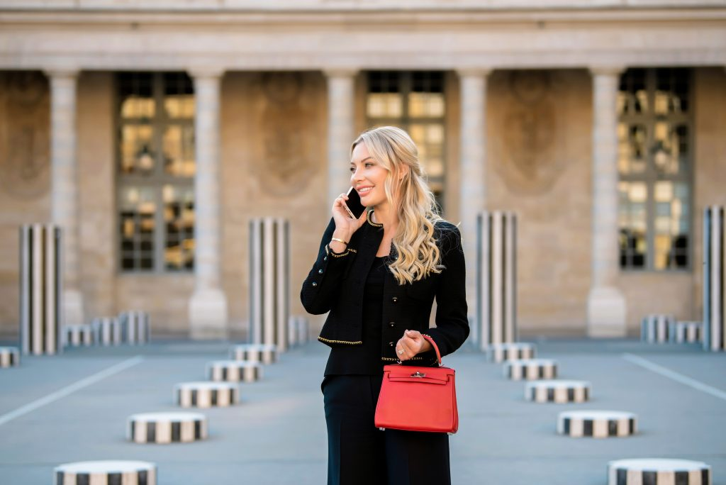 A woman carrying a luxury bag in the city.