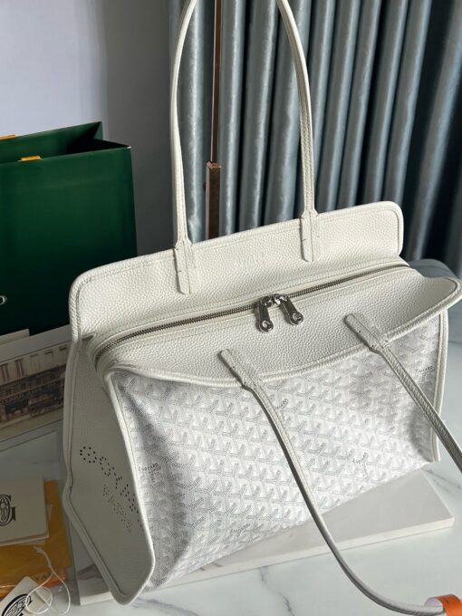 Hardy PM Bag. Authentic quality luxury bag crafted in genuine leather comes with authenticity card, dust bag and gift bag. Effortless Elegance, Everyday Function. The Hardy PM bag is the perfect companion for everyday use or work, easily fitting A4 files with ease. Designed for those who value lightness, flexibility, and added security, it features a zip closure to keep your essentials safe. With long, comfortable handles, it's ideal for carrying over the shoulder all day with ease.