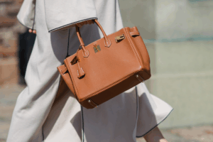 Confident woman walking with a luxury-inspired handbag