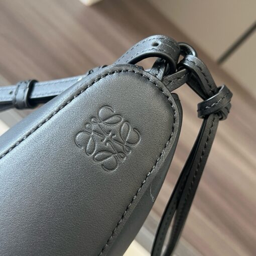 Mini Hammock Hobo. Authentic quality luxury bag crafted in genuine leather comes with authenticity card, dust bag and gift bag. Effortless Form, Everyday Function.  The Mini Hammock Hobo is a contemporary reimagining of Loewe’s iconic Hammock bag. This streamlined variation offers a sleek, sculptural silhouette designed as a versatile sling bag for modern living. Expertly crafted in classic calfskin, it features soft, supple leather and a compact form that adapts effortlessly to your day. The unique design allows for multiple carry options—wear it crossbody, over the shoulder, or by hand. Elegant yet functional, this mini hobo is perfect for essentials, making it an ideal choice for both daily wear and minimalist style statements.