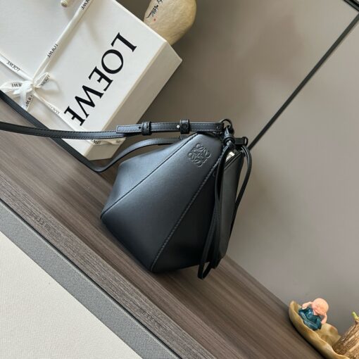 Mini Hammock Hobo. Authentic quality luxury bag crafted in genuine leather comes with authenticity card, dust bag and gift bag. Effortless Form, Everyday Function.  The Mini Hammock Hobo is a contemporary reimagining of Loewe’s iconic Hammock bag. This streamlined variation offers a sleek, sculptural silhouette designed as a versatile sling bag for modern living. Expertly crafted in classic calfskin, it features soft, supple leather and a compact form that adapts effortlessly to your day. The unique design allows for multiple carry options—wear it crossbody, over the shoulder, or by hand. Elegant yet functional, this mini hobo is perfect for essentials, making it an ideal choice for both daily wear and minimalist style statements.