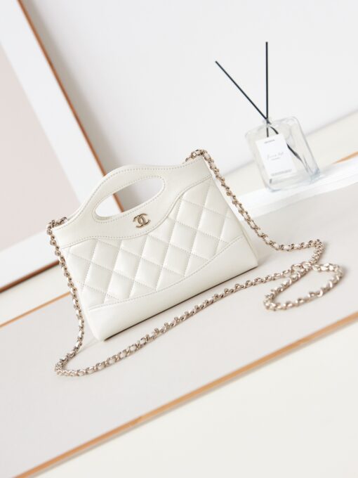 31 Nano Shopping Bag. Authentic quality luxury bag crafted in genuine leather comes with authenticity card, dust bag and gift bag. Small in size, grand in statement.  A miniature marvel that captures the sophistication of *ANEL in its most playful form. Crafted with meticulous precision, this petite icon merges the timeless spirit of the *ANEL 31 with a modern twist on everyday elegance. Designed in supple lambskin and finished with gleaming gold-tone hardware, the Nano 31 doesn’t just carry your essentials — it carries your attitude. Whether worn crossbody, by hand, or dangling from the crook of your arm, this charming piece elevates every ensemble with a whisper of Parisian chic. Perfect for a night out or a day in the spotlight, it’s not just a bag — it’s your boldest accessory in its most compact form. Because luxury doesn't need to shout. Sometimes, it just needs to charm.