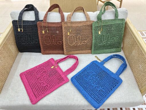 Summer Banana Tote Bag. Authentic quality luxury bag crafted in genuine leather comes with authenticity card, dust bag and gift bag. Heritage in Hand: Where Artisan Craft Meets Summer Elegance. Introducing the Summer Banana Tote—an artisanal masterpiece crafted from raffia and calfskin by a single artisan over 4.5 days in partnership with Made For A Woman. This spacious tote is adorned with a handwritten signature inspired by *loé’s rich heritage, while a playful dangling chain and delicate charms add the perfect finishing touch. A celebration of craftsmanship and effortless summer style.