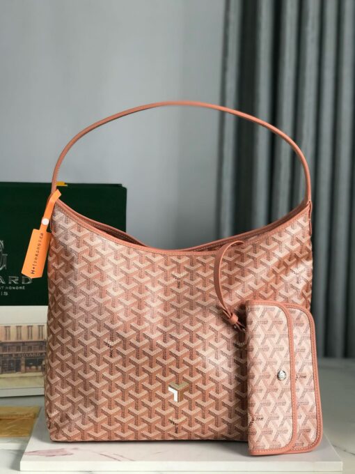 Bohème Hobo Bag. Authentic quality luxury bag crafted in genuine leather comes with authenticity card, dust bag and gift bag. Wander Freely. Carry Elegantly. Introducing the Goyard Bohème Hobo Bag—a tribute to Parisian spirit and wanderlust. Inspired by the timber raftsmen’s humble travel pouches, this bag blends heritage storytelling with everyday luxury. Crafted to be exceptionally lightweight and flexible, it drapes effortlessly on your shoulder with a wide, comfortable handle designed for long city strolls or spontaneous weekend escapes. Its beauty lies not only in its sleek silhouette but also in its thoughtful functionality. The secure zip closure keeps your essentials safe, while the removable snap-fastened pouch doubles as a chic clutch or wallet—perfect for a quick dash or stylish switch-up. Whether you’re wandering through cobblestone streets or navigating your daily routine, the Bohème ensures your essentials are always within reach. This is not just a bag—it’s your elegant partner in carefree adventures.