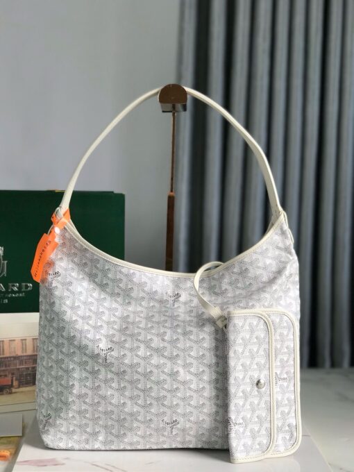 Bohème Hobo Bag. Authentic quality luxury bag crafted in genuine leather comes with authenticity card, dust bag and gift bag. Wander Freely. Carry Elegantly. Introducing the Goyard Bohème Hobo Bag—a tribute to Parisian spirit and wanderlust. Inspired by the timber raftsmen’s humble travel pouches, this bag blends heritage storytelling with everyday luxury. Crafted to be exceptionally lightweight and flexible, it drapes effortlessly on your shoulder with a wide, comfortable handle designed for long city strolls or spontaneous weekend escapes. Its beauty lies not only in its sleek silhouette but also in its thoughtful functionality. The secure zip closure keeps your essentials safe, while the removable snap-fastened pouch doubles as a chic clutch or wallet—perfect for a quick dash or stylish switch-up. Whether you’re wandering through cobblestone streets or navigating your daily routine, the Bohème ensures your essentials are always within reach. This is not just a bag—it’s your elegant partner in carefree adventures.