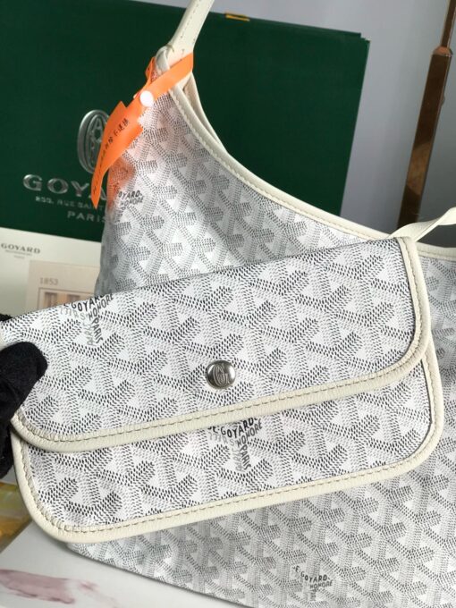 Bohème Hobo Bag. Authentic quality luxury bag crafted in genuine leather comes with authenticity card, dust bag and gift bag. Wander Freely. Carry Elegantly. Introducing the Goyard Bohème Hobo Bag—a tribute to Parisian spirit and wanderlust. Inspired by the timber raftsmen’s humble travel pouches, this bag blends heritage storytelling with everyday luxury. Crafted to be exceptionally lightweight and flexible, it drapes effortlessly on your shoulder with a wide, comfortable handle designed for long city strolls or spontaneous weekend escapes. Its beauty lies not only in its sleek silhouette but also in its thoughtful functionality. The secure zip closure keeps your essentials safe, while the removable snap-fastened pouch doubles as a chic clutch or wallet—perfect for a quick dash or stylish switch-up. Whether you’re wandering through cobblestone streets or navigating your daily routine, the Bohème ensures your essentials are always within reach. This is not just a bag—it’s your elegant partner in carefree adventures.