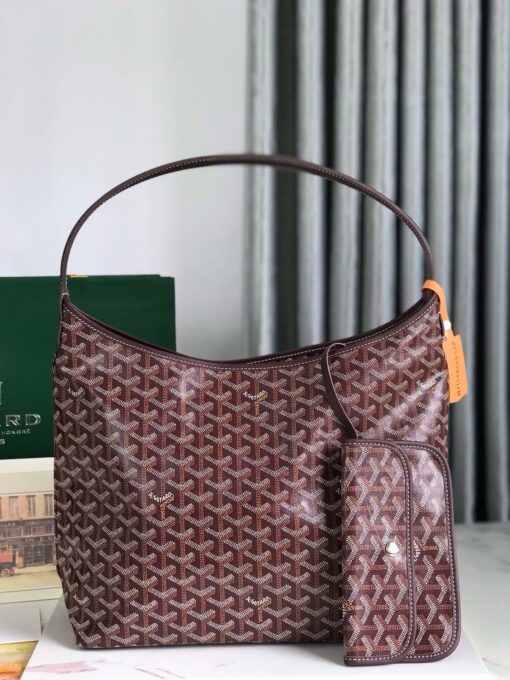 Bohème Hobo Bag. Authentic quality luxury bag crafted in genuine leather comes with authenticity card, dust bag and gift bag. Wander Freely. Carry Elegantly. Introducing the Goyard Bohème Hobo Bag—a tribute to Parisian spirit and wanderlust. Inspired by the timber raftsmen’s humble travel pouches, this bag blends heritage storytelling with everyday luxury. Crafted to be exceptionally lightweight and flexible, it drapes effortlessly on your shoulder with a wide, comfortable handle designed for long city strolls or spontaneous weekend escapes. Its beauty lies not only in its sleek silhouette but also in its thoughtful functionality. The secure zip closure keeps your essentials safe, while the removable snap-fastened pouch doubles as a chic clutch or wallet—perfect for a quick dash or stylish switch-up. Whether you’re wandering through cobblestone streets or navigating your daily routine, the Bohème ensures your essentials are always within reach. This is not just a bag—it’s your elegant partner in carefree adventures.