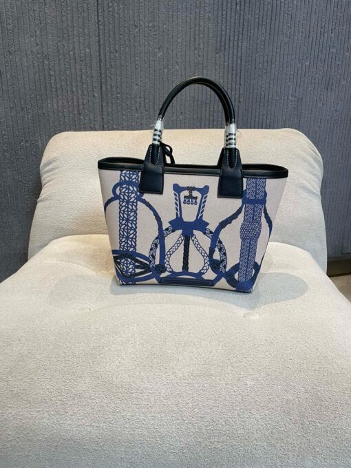 Steeple 25 Bag. Authentic quality luxury bag crafted in genuine leather comes with authenticity card, dust bag and gift bag. Where art meets heritage. The *rmès Steeple Bag is a charming fusion of heritage and artistry, crafted from a blend of canvas and Swift leather. Its design pays tribute to *rmès’ equestrian roots with whip-shaped handles and a stirrup-inspired charm, adding a playful yet sophisticated touch. Lightweight yet spacious, the Steeple is ideal for daily use. Whether you opt for a vibrant motif or a sleek, single-color design, this bag stands out as an artistic expression of luxury that seamlessly integrates into a modern lifestyle. Praised for its unique aesthetic and accessibility within the *rmès lineup, the Steeple Bag is adored by fashion enthusiasts who appreciate its colorful palette and bold personality. While it’s best suited for those who enjoy the texture and look of canvas, it remains a versatile statement piece that captures the spirit of everyday elegance.