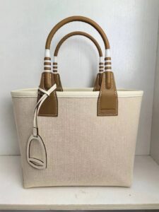 Steeple 25 Bag. Authentic quality luxury bag crafted in genuine leather comes with authenticity card, dust bag and gift bag. Where art meets heritage. The *rmès Steeple Bag is a charming fusion of heritage and artistry, crafted from a blend of canvas and Swift leather. Its design pays tribute to *rmès’ equestrian roots with whip-shaped handles and a stirrup-inspired charm, adding a playful yet sophisticated touch. Lightweight yet spacious, the Steeple is ideal for daily use. Whether you opt for a vibrant motif or a sleek, single-color design, this bag stands out as an artistic expression of luxury that seamlessly integrates into a modern lifestyle. Praised for its unique aesthetic and accessibility within the *rmès lineup, the Steeple Bag is adored by fashion enthusiasts who appreciate its colorful palette and bold personality. While it’s best suited for those who enjoy the texture and look of canvas, it remains a versatile statement piece that captures the spirit of everyday elegance. - CRIS&COCO Steeple 25 Bag. Authentic quality luxury bag crafted in genuine leather comes with authenticity card, dust bag and gift bag. Where art meets heritage. The *rmès Steeple Bag is a charming fusion of heritage and artistry, crafted from a blend of canvas and Swift leather. Its design pays tribute to *rmès’ equestrian roots with whip-shaped handles and a stirrup-inspired charm, adding a playful yet sophisticated touch. Lightweight yet spacious, the Steeple is ideal for daily use. Whether you opt for a vibrant motif or a sleek, single-color design, this bag stands out as an artistic expression of luxury that seamlessly integrates into a modern lifestyle. Praised for its unique aesthetic and accessibility within the *rmès lineup, the Steeple Bag is adored by fashion enthusiasts who appreciate its colorful palette and bold personality. While it’s best suited for those who enjoy the texture and look of canvas, it remains a versatile statement piece that captures the spirit of everyday elegance.