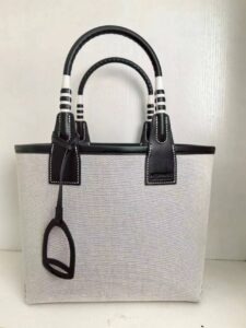 Steeple 25 Bag. Authentic quality luxury bag crafted in genuine leather comes with authenticity card, dust bag and gift bag. Where art meets heritage. The *rmès Steeple Bag is a charming fusion of heritage and artistry, crafted from a blend of canvas and Swift leather. Its design pays tribute to *rmès’ equestrian roots with whip-shaped handles and a stirrup-inspired charm, adding a playful yet sophisticated touch. Lightweight yet spacious, the Steeple is ideal for daily use. Whether you opt for a vibrant motif or a sleek, single-color design, this bag stands out as an artistic expression of luxury that seamlessly integrates into a modern lifestyle. Praised for its unique aesthetic and accessibility within the *rmès lineup, the Steeple Bag is adored by fashion enthusiasts who appreciate its colorful palette and bold personality. While it’s best suited for those who enjoy the texture and look of canvas, it remains a versatile statement piece that captures the spirit of everyday elegance. - CRIS&COCO Steeple 25 Bag. Authentic quality luxury bag crafted in genuine leather comes with authenticity card, dust bag and gift bag. Where art meets heritage. The *rmès Steeple Bag is a charming fusion of heritage and artistry, crafted from a blend of canvas and Swift leather. Its design pays tribute to *rmès’ equestrian roots with whip-shaped handles and a stirrup-inspired charm, adding a playful yet sophisticated touch. Lightweight yet spacious, the Steeple is ideal for daily use. Whether you opt for a vibrant motif or a sleek, single-color design, this bag stands out as an artistic expression of luxury that seamlessly integrates into a modern lifestyle. Praised for its unique aesthetic and accessibility within the *rmès lineup, the Steeple Bag is adored by fashion enthusiasts who appreciate its colorful palette and bold personality. While it’s best suited for those who enjoy the texture and look of canvas, it remains a versatile statement piece that captures the spirit of everyday elegance.