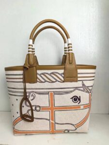 Steeple 25 Bag. Authentic quality luxury bag crafted in genuine leather comes with authenticity card, dust bag and gift bag. Where art meets heritage. The *rmès Steeple Bag is a charming fusion of heritage and artistry, crafted from a blend of canvas and Swift leather. Its design pays tribute to *rmès’ equestrian roots with whip-shaped handles and a stirrup-inspired charm, adding a playful yet sophisticated touch. Lightweight yet spacious, the Steeple is ideal for daily use. Whether you opt for a vibrant motif or a sleek, single-color design, this bag stands out as an artistic expression of luxury that seamlessly integrates into a modern lifestyle. Praised for its unique aesthetic and accessibility within the *rmès lineup, the Steeple Bag is adored by fashion enthusiasts who appreciate its colorful palette and bold personality. While it’s best suited for those who enjoy the texture and look of canvas, it remains a versatile statement piece that captures the spirit of everyday elegance. - CRIS&COCO Steeple 25 Bag. Authentic quality luxury bag crafted in genuine leather comes with authenticity card, dust bag and gift bag. Where art meets heritage. The *rmès Steeple Bag is a charming fusion of heritage and artistry, crafted from a blend of canvas and Swift leather. Its design pays tribute to *rmès’ equestrian roots with whip-shaped handles and a stirrup-inspired charm, adding a playful yet sophisticated touch. Lightweight yet spacious, the Steeple is ideal for daily use. Whether you opt for a vibrant motif or a sleek, single-color design, this bag stands out as an artistic expression of luxury that seamlessly integrates into a modern lifestyle. Praised for its unique aesthetic and accessibility within the *rmès lineup, the Steeple Bag is adored by fashion enthusiasts who appreciate its colorful palette and bold personality. While it’s best suited for those who enjoy the texture and look of canvas, it remains a versatile statement piece that captures the spirit of everyday elegance.