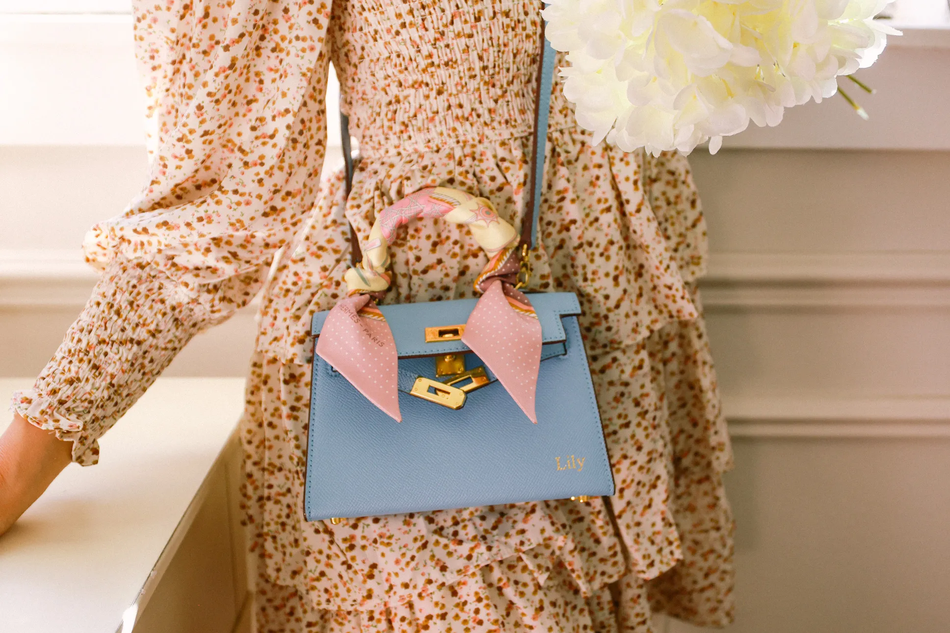 Mini pink replica KELLY bag on marble café table with coffee and Vogue magazine Mini pink replica KELLY bag on marble café table with coffee and Vogue magazine