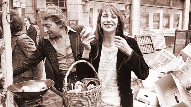 Jane Birkin seated in a cafe with her straw basket on the floor Jane Birkin seated in a cafe with her straw basket on the floor