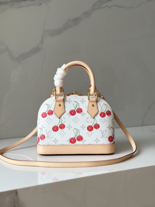 LV x TM Alma BB. Authentic quality luxury bag crafted in genuine leather comes with authenticity card, dust bag and gift bag. A Joyful Icon Reimagined. Playful, artistic, and instantly iconic—the Alma BB returns in a joyful re-edition as part of the celebrated LV x TM collection. This petite masterpiece blends the timeless Art Deco-inspired silhouette with Takashi Murakami’s signature whimsy, splashing the House’s Monogram canvas with bold, cherry-bright motifs. Crafted with natural leather accents and finished with polished gold-tone hardware, it features structured Toron top handles and a charming bow-shaped keybell that adds just the right amount of flirt. Compact yet attention-commanding, the Alma BB is a true collectible—full of joy, color, and unmistakable LV heritage. Carry art. Wear happiness. Make a statement.