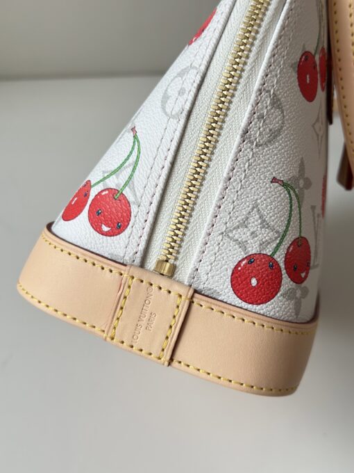 LV x TM Alma BB. Authentic quality luxury bag crafted in genuine leather comes with authenticity card, dust bag and gift bag. A Joyful Icon Reimagined. Playful, artistic, and instantly iconic—the Alma BB returns in a joyful re-edition as part of the celebrated LV x TM collection. This petite masterpiece blends the timeless Art Deco-inspired silhouette with Takashi Murakami’s signature whimsy, splashing the House’s Monogram canvas with bold, cherry-bright motifs. Crafted with natural leather accents and finished with polished gold-tone hardware, it features structured Toron top handles and a charming bow-shaped keybell that adds just the right amount of flirt. Compact yet attention-commanding, the Alma BB is a true collectible—full of joy, color, and unmistakable LV heritage. Carry art. Wear happiness. Make a statement.
