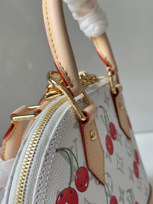 LV x TM Alma BB. Authentic quality luxury bag crafted in genuine leather comes with authenticity card, dust bag and gift bag. A Joyful Icon Reimagined. Playful, artistic, and instantly iconic—the Alma BB returns in a joyful re-edition as part of the celebrated LV x TM collection. This petite masterpiece blends the timeless Art Deco-inspired silhouette with Takashi Murakami’s signature whimsy, splashing the House’s Monogram canvas with bold, cherry-bright motifs. Crafted with natural leather accents and finished with polished gold-tone hardware, it features structured Toron top handles and a charming bow-shaped keybell that adds just the right amount of flirt. Compact yet attention-commanding, the Alma BB is a true collectible—full of joy, color, and unmistakable LV heritage. Carry art. Wear happiness. Make a statement.
