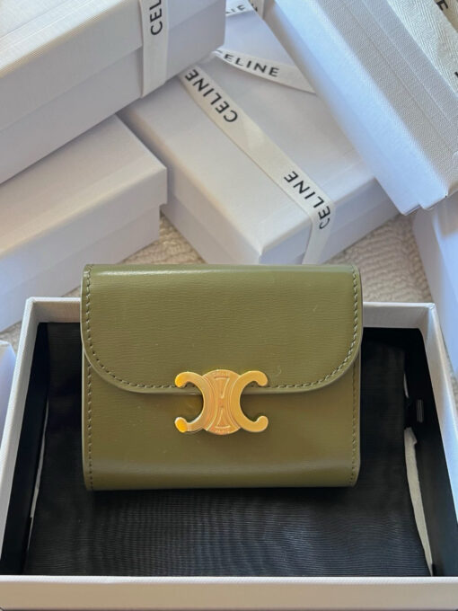 Small Flap Wallet Triomphe. Authentic quality luxury bag crafted in genuine leather comes with authenticity card, dust bag and gift bag. Small in Size, Grand in Style. Discover timeless sophistication in the palm of your hand with the *ELINE Small Flap Wallet TRIOMPHE in shiny calfskin. Meticulously crafted from luxurious leather, this compact beauty showcases the iconic Triomphe clasp in gold-tone metal, a refined nod to Parisian heritage. Despite its petite size, it opens to reveal smart compartments for cards, bills, and coins—proving that style never compromises function. Whether tucked into your favorite designer bag or carried solo for a night out, this wallet is your everyday dose of quiet luxury.