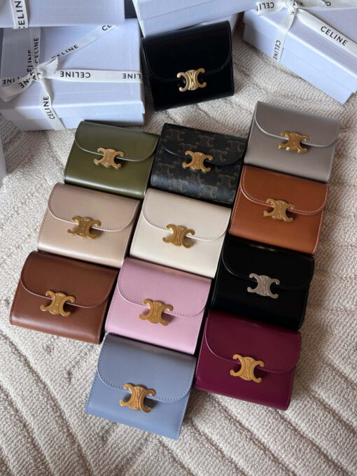 Small Flap Wallet Triomphe. Authentic quality luxury bag crafted in genuine leather comes with authenticity card, dust bag and gift bag. Small in Size, Grand in Style. Discover timeless sophistication in the palm of your hand with the *ELINE Small Flap Wallet TRIOMPHE in shiny calfskin. Meticulously crafted from luxurious leather, this compact beauty showcases the iconic Triomphe clasp in gold-tone metal, a refined nod to Parisian heritage. Despite its petite size, it opens to reveal smart compartments for cards, bills, and coins—proving that style never compromises function. Whether tucked into your favorite designer bag or carried solo for a night out, this wallet is your everyday dose of quiet luxury.