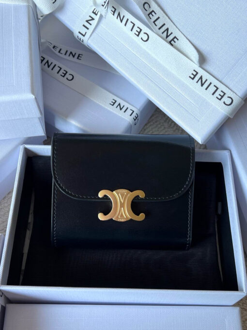 Small Flap Wallet Triomphe. Authentic quality luxury bag crafted in genuine leather comes with authenticity card, dust bag and gift bag. Small in Size, Grand in Style. Discover timeless sophistication in the palm of your hand with the *ELINE Small Flap Wallet TRIOMPHE in shiny calfskin. Meticulously crafted from luxurious leather, this compact beauty showcases the iconic Triomphe clasp in gold-tone metal, a refined nod to Parisian heritage. Despite its petite size, it opens to reveal smart compartments for cards, bills, and coins—proving that style never compromises function. Whether tucked into your favorite designer bag or carried solo for a night out, this wallet is your everyday dose of quiet luxury.