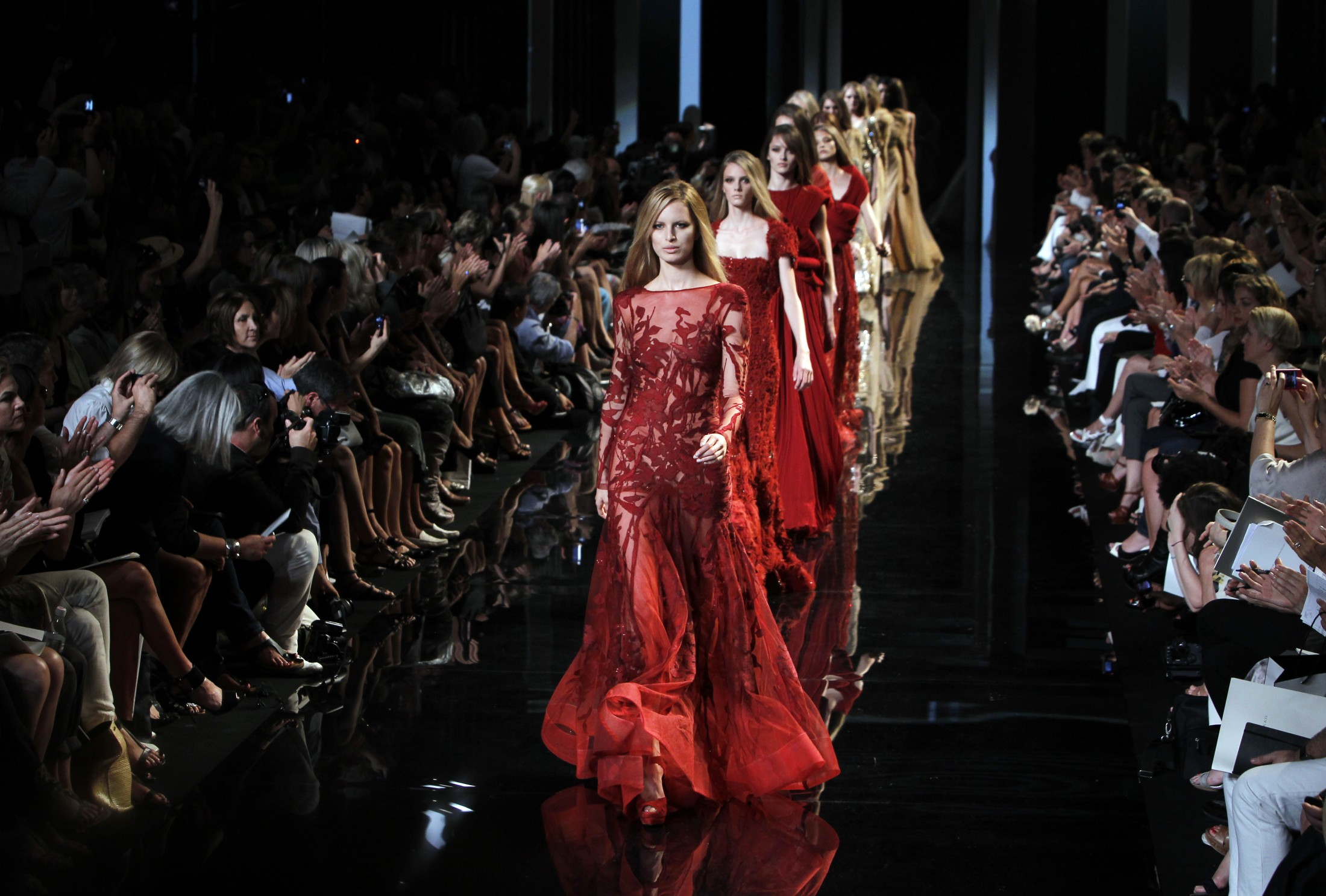 Luxury on the runway, stitched in silence. The true cost walks behind the curtain. 
