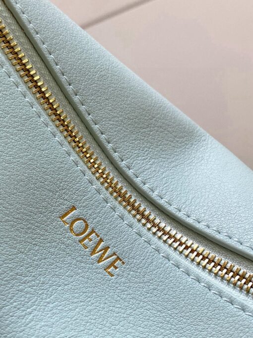 Puzzle Fold Pouch. Authentic quality luxury bag crafted in genuine leather comes with authenticity card, dust bag and gift bag. Sculpted Sophistication — The Art of Function. The Puzzle Fold Pouch redefines modern elegance with its sculptural geometry and effortless versatility. Crafted in luxurious shiny nappa calfskin, its signature folded panels create a dynamic, architectural silhouette that’s instantly recognizable. Both stylish and practical, this pouch transitions seamlessly from day to night—perfect for carrying essentials with a touch of *OEWE sophistication. A masterpiece of craftsmanship, it’s the ultimate blend of innovation and timeless design.