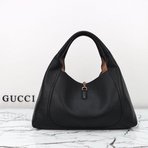 Softbit Maxi Shoulder Bag. Authentic quality luxury bag crafted in genuine leather comes with authenticity card, dust bag and gift bag. Icon Reimagined: Effortless Luxury with a Modern Bit of Bold. *ucci’s timeless heritage meets contemporary ease in the new Softbit Shoulder Bag. Crafted from supple grained leather with a luxuriously rich texture, this piece balances sophistication and function effortlessly. At its heart lies an oversized half-horsebit — a bold reinterpretation of the House’s iconic detail — accenting the magnetic closure with statement appeal. With its relaxed silhouette and refined craftsmanship, the Softbit is the perfect companion for those who favor effortless elegance with a modern edge.