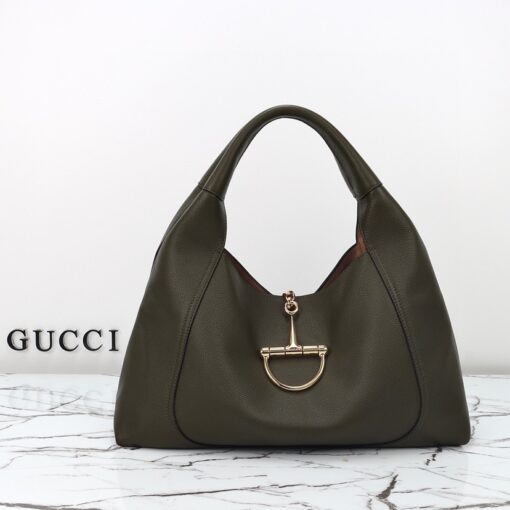 Softbit Maxi Shoulder Bag. Authentic quality luxury bag crafted in genuine leather comes with authenticity card, dust bag and gift bag. Icon Reimagined: Effortless Luxury with a Modern Bit of Bold. *ucci’s timeless heritage meets contemporary ease in the new Softbit Shoulder Bag. Crafted from supple grained leather with a luxuriously rich texture, this piece balances sophistication and function effortlessly. At its heart lies an oversized half-horsebit — a bold reinterpretation of the House’s iconic detail — accenting the magnetic closure with statement appeal. With its relaxed silhouette and refined craftsmanship, the Softbit is the perfect companion for those who favor effortless elegance with a modern edge.
