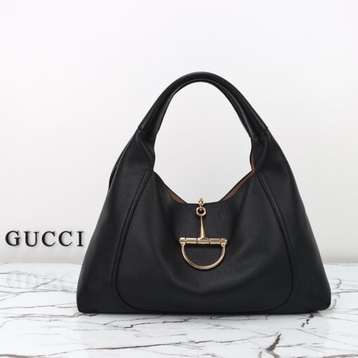 Softbit Maxi Shoulder Bag. Authentic quality luxury bag crafted in genuine leather comes with authenticity card, dust bag and gift bag. Icon Reimagined: Effortless Luxury with a Modern Bit of Bold. *ucci’s timeless heritage meets contemporary ease in the new Softbit Shoulder Bag. Crafted from supple grained leather with a luxuriously rich texture, this piece balances sophistication and function effortlessly. At its heart lies an oversized half-horsebit — a bold reinterpretation of the House’s iconic detail — accenting the magnetic closure with statement appeal. With its relaxed silhouette and refined craftsmanship, the Softbit is the perfect companion for those who favor effortless elegance with a modern edge.